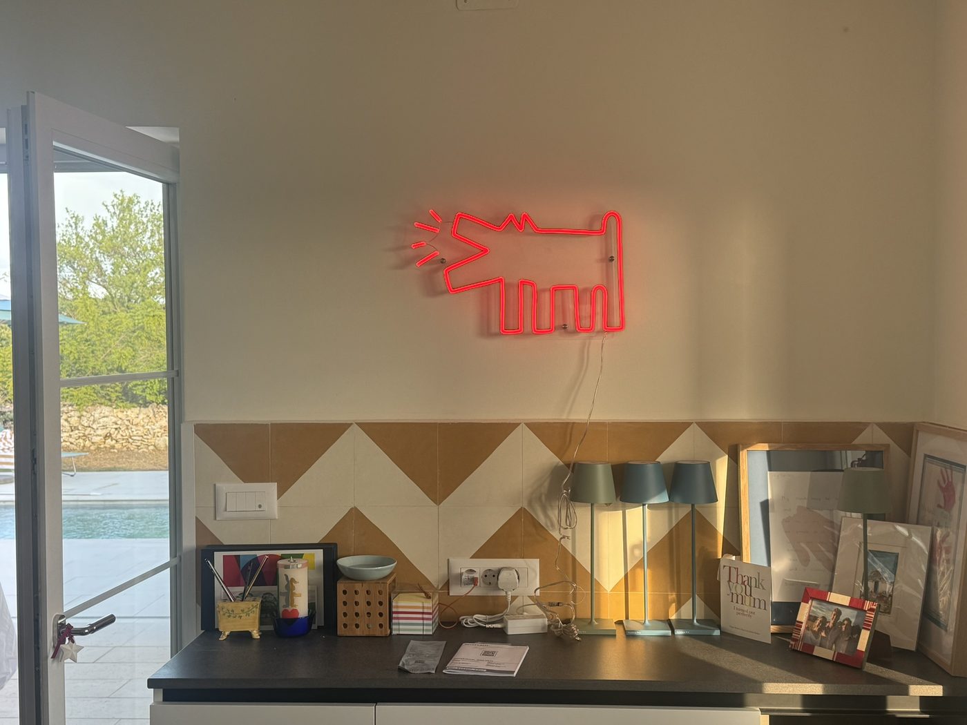 The neon dog above the kitchen counter