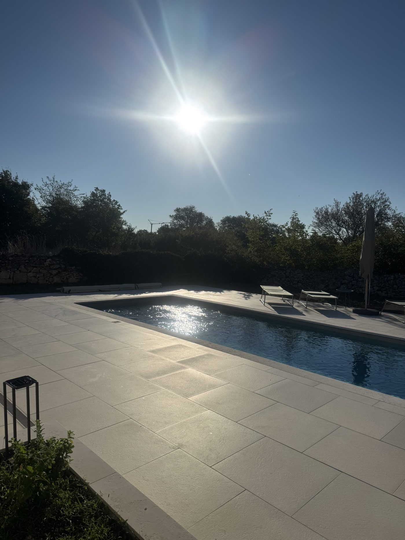 The pool and stone terrace in the morning sun